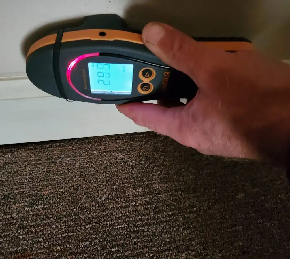 Moisture detection at baseboard during Storm Damage Restoration in Pompton Lakes
